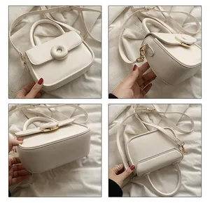 Detail view of cream white mini crossbody bag showing front, side, and bottom leather texture