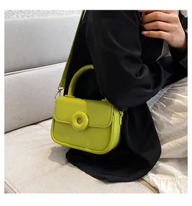 Fluorescent green PU leather crossbody bag with round buckle shown on a model