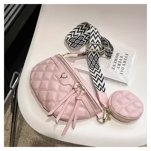 Pink quilted crossbody bag with metal deer ornament and geometric wide strap