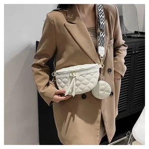 White quilted crossbody bag set with geometric strap shown on a brown blazer outfit