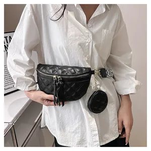 Detail view of black quilted leather waist bag with detachable round coin purse and woven strap