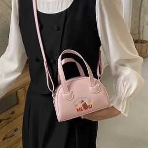 Detailed embroidery of a Christmas bear on a pink PU leather crossbody bag