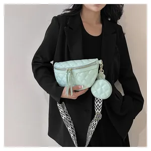 Detail of mint green quilted waist bag with geometric strap and round coin purse