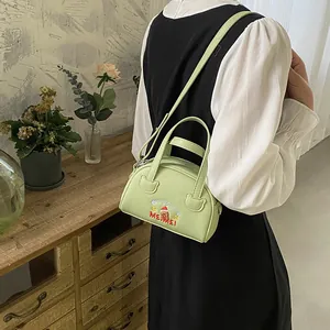 Detail of mint green crossbody bag with Christmas puppy embroidery and adjustable strap