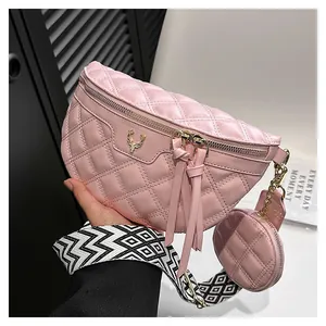 Pink quilted crossbody bag set with golden deer logo and geometric patterned strap