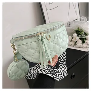 Mint green quilted fanny pack with golden deer ornament and wide geometric strap