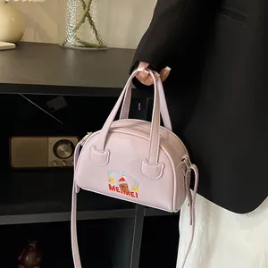 Close-up of lavender purple Boston bag with exquisite bear embroidery and fine PU texture