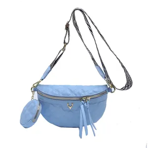 Quilted light blue waist bag with deer logo and matching round coin purse charm