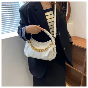 Detail of white PU leather bag with chunky gold chain and woven braided handle