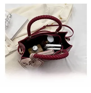 Interior view of burgundy handbag showing spacious capacity for phone and accessories
