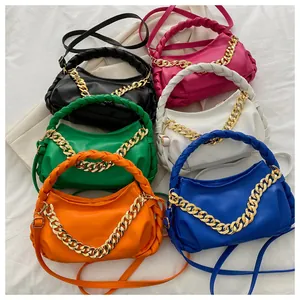 Detailed view of women's pleated chain handbags in six vibrant colors on soft fabric