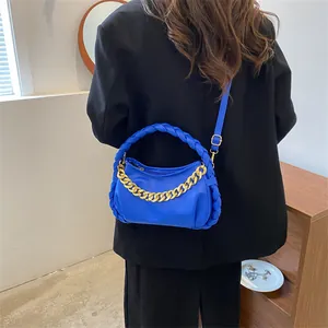 Blue crossbody chain bag with braided handle and gold metal links for women