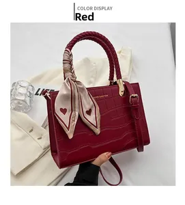Red crocodile embossed leather handbag with woven handle and elegant silk scarf detail