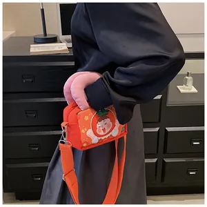 Orange canvas crossbody bag featuring a strawberry girl cartoon and pink plush handle