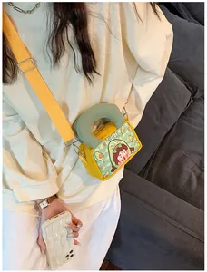 Close-up of a yellow canvas crossbody bag featuring a cute cartoon girl illustration