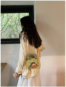 Fashionable crossbody canvas bag in yellow with cute cartoon girl and avocado prints
