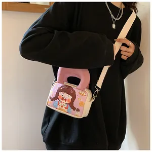 Detail of cartoon girl illustration on small beige canvas crossbody bag with pink handle