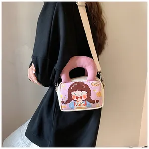 Detail of cartoon canvas bag with pink plush handle and stylish crossbody strap