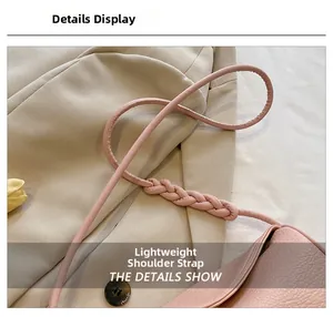 Detail of pink shoulder strap with braided leather texture and sleek circular design
