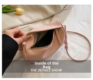 Close-up of pink litchi grain leather bag interior with zipper and spacious compartment