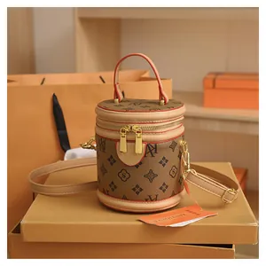 Detailed view of the vintage cylinder bucket bag with monogram pattern and gold hardware
