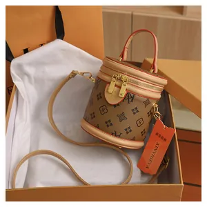 Close-up of vintage brown monogram bucket bag with leather trim in a gift box