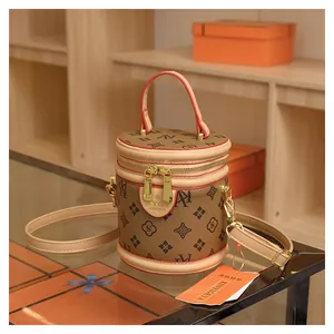 Detail of vintage monogram bucket bag with round handle and gold-tone zippers