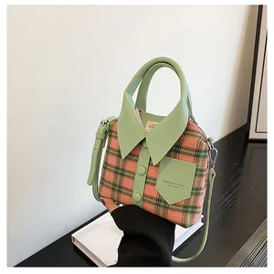 Pink and green plaid shirt-shaped handbag with adjustable strap and leather details