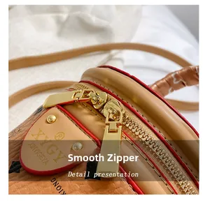 Macro shot of smooth golden dual zipper and textured brown leather on a bucket bag