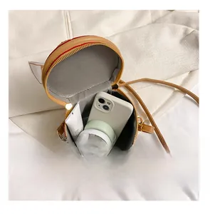 Top view of compact bucket bag showing interior space with phone and cosmetics