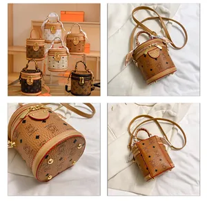Detail showing litchi grain bucket bag with decorative scarf handle and metal zipper
