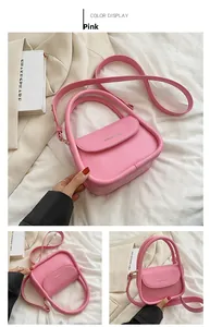 Pink minimalist crossbody bag with smooth PU leather and metal logo detail closeup