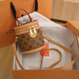 Retro brown cylinder bucket bag with monogram texture and adjustable shoulder strap