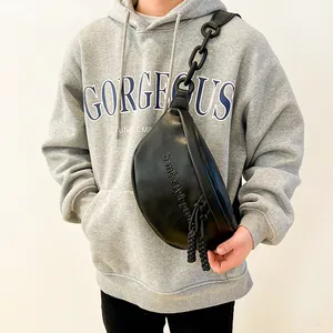 Black pleated half-moon crossbody bag with chunky chain strap and embossed details