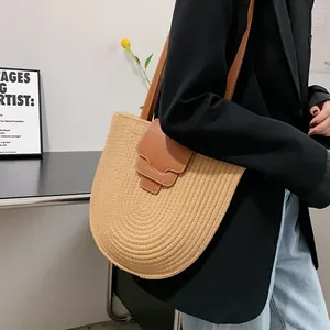Handmade straw bucket bag with brown leather trim and handle for summer casual style