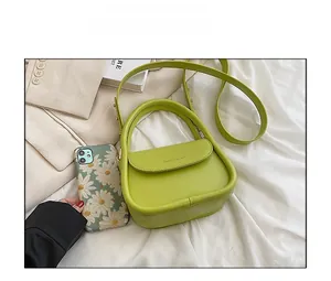 Detailed comparison showing compact grass green handbag size with a floral phone case