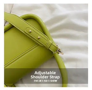Detail of avocado green leather bag featuring adjustable strap and gold hardware