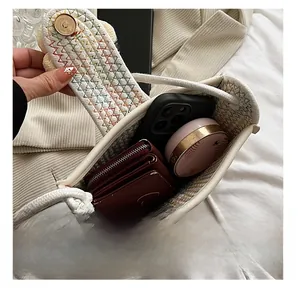 Interior view of white woven crossbody bag showing space for phone and makeup