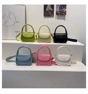 Row of small square PU leather handbags in various pastel colors with round handles