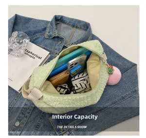 Internal capacity of light green ruched cloud bag showing storage for tablet and umbrella