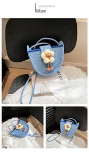 Detail view showing blue woven crossbody bag with a 3D plush flower and rope strap