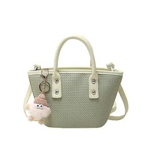 Chic light green woven PU leather bucket bag with top handles and plush pendant