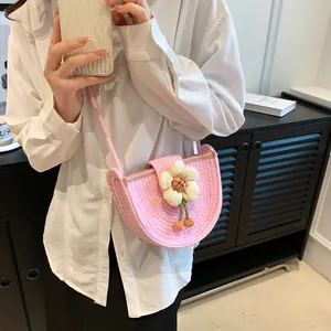 Pink woven crossbody bag with cream flower decor and fruit pendant for women