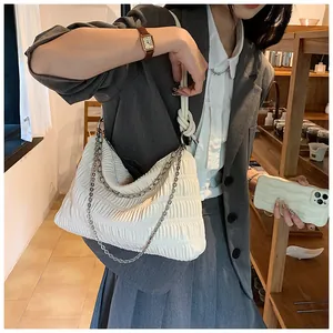 Detail of off-white pleated tote bag featuring silver chain and rope knot shoulder strap