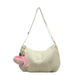 Minimalist creamy white pleated hobo shoulder bag with a cute pink strawberry plush charm