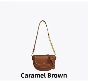 Détail du sac besace marron caramel avec chaîne dorée et texture en cuir lisse