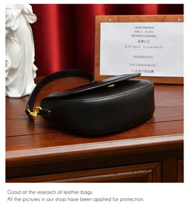 Détail du sac selle vintage en cuir marron foncé avec boucle en métal doré élégante