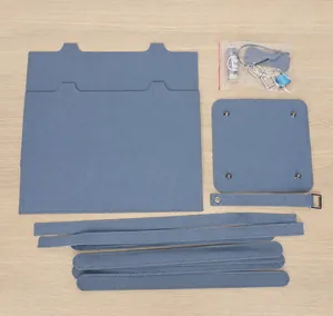 Flat lay of DIY bucket bag kit components including foggy blue leather and hardware