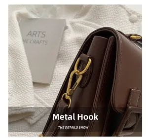 Detail shot of the vintage brown leather bag featuring premium gold hardware hooks