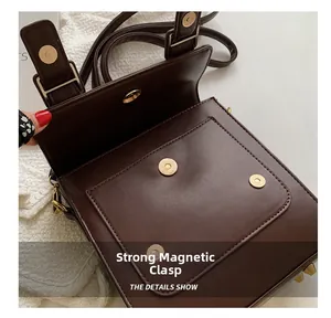 Close-up of a retro brown crossbody bag featuring strong magnetic buckle closures
